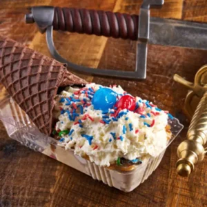 Decadent ice cream sundae cone topped with sweet goodness.